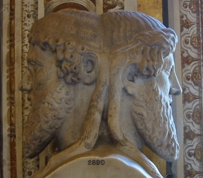 Janus: "The god of beginnings and transitions,[1] and thereby of gates, doors, doorways, passages and endings. He is usually depicted as having two faces, since he looks to the future and to the past."
